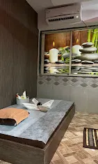 Massage room with candle and stone decor