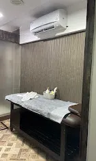 Clean private massage room with AC